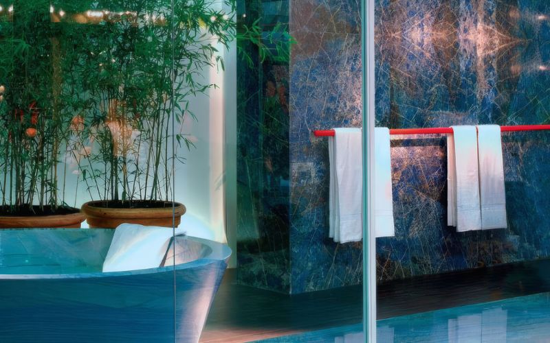 Granite bathroom wall slab with towel hooks.